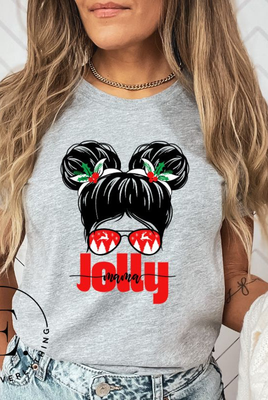 Get into the holiday spirit with our "Jolly Mama" Christmas Shirt! Featuring a stylish mom rocking pigtail buns and festive Christmas Sunglasses on a athletic heather grey colored shirt.