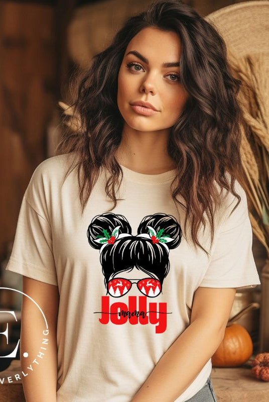 Get into the holiday spirit with our "Jolly Mama" Christmas Shirt! Featuring a stylish mom rocking pigtail buns and festive Christmas Sunglasses on a tan colored shirt.