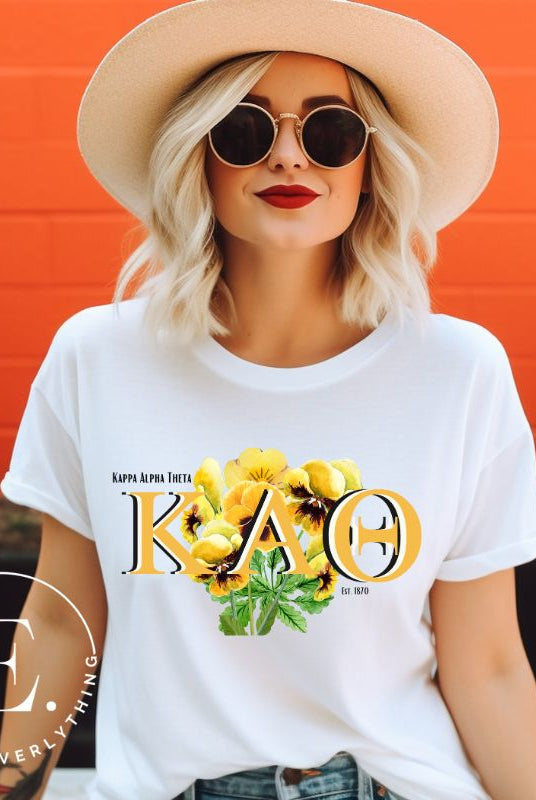 Show your Kappa Alpha Theta pride with our sorority t-shirt! Our design features the sorority letters and a striking black and gold pansy, symbolizing sisterhood and strength on a white shirt. 