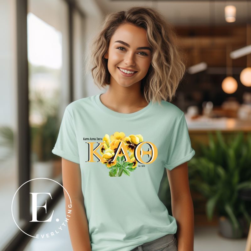 Get ready to show your Kappa Alpha Theta pride with our stunning sublimation t-shirt download featuring the sorority's letters and the elegant black and gold pansy on a mint shirt. 