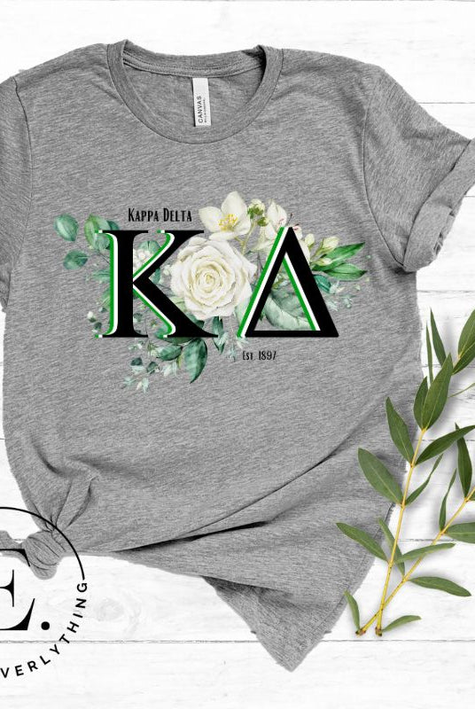 Elevate your Kappa Delta sisterhood with our stunning t-shirt, featuring the sorority letters and the elegant white rose on a grey shirt. 