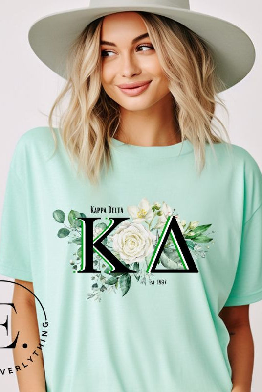 Elevate your Kappa Delta sisterhood with our stunning t-shirt, featuring the sorority letters and the elegant white rose on a mint shirt. 