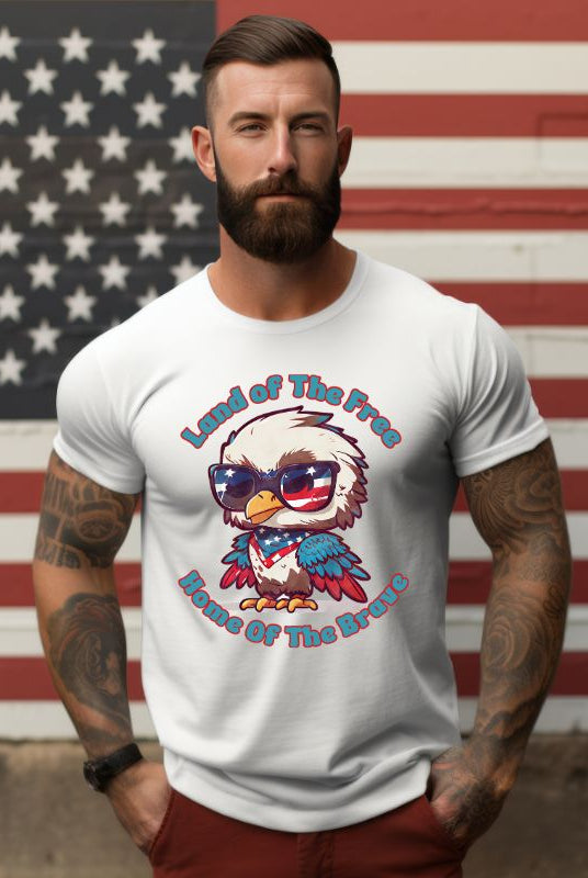 Graphic of a bird wearing sunglasses and a USA-themed scarf, with the text 'Land of the Free, Home of the Brave' on the front of a white graphic tee.