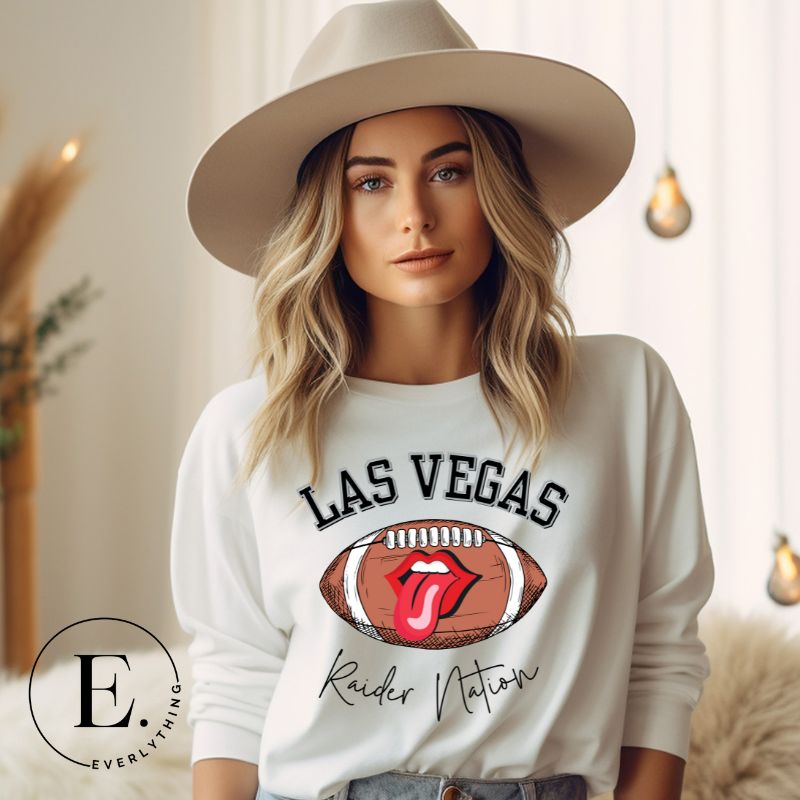 Get ready to support the Las Vegas Raiders in style with our premium sweatshirt, featuring the team's name and iconic slogan, "Raider Nation." On a white sweatshirt. 