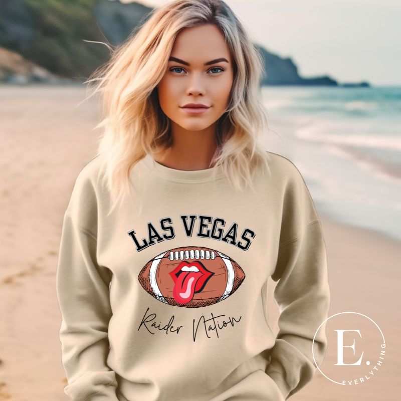 Get ready to support the Las Vegas Raiders in style with our premium sweatshirt, featuring the team's name and iconic slogan, "Raider Nation." on a sand colored sweatshirt. 