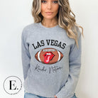 Get ready to support the Las Vegas Raiders in style with our premium sweatshirt, featuring the team's name and iconic slogan, "Raider Nation." On a grey sweatshirt. 