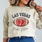 Get ready to support the Las Vegas Raiders in style with our premium sweatshirt, featuring the team's name and iconic slogan, "Raider Nation." On a sand colored sweatshirt. 