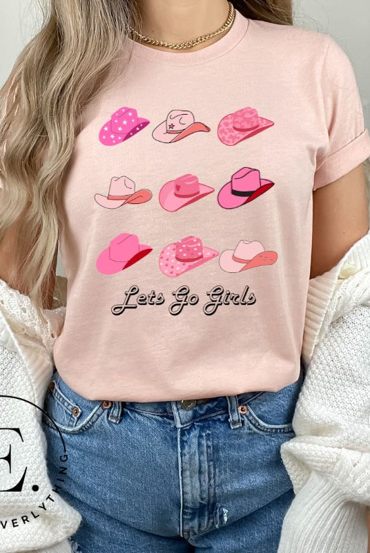 Get ready to wrangle in style with our country western shirt collection. Featuring a variety of pink cowboy hats and the classic phrase "Let's Go Girls," on a pink shirt. 