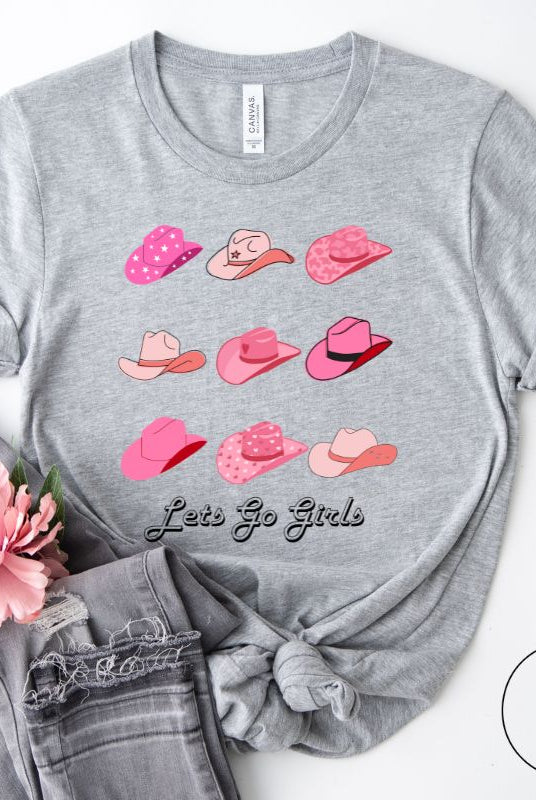 Get ready to wrangle in style with our country western shirt collection. Featuring a variety of pink cowboy hats and the classic phrase "Let's Go Girls," on a grey shirt. 