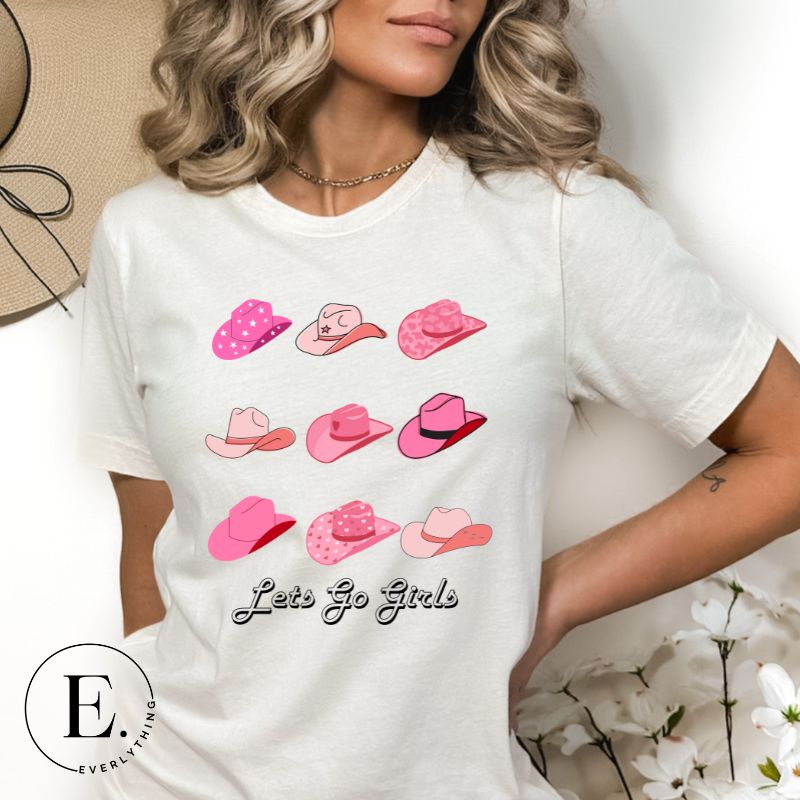 Get ready to wrangle in style with our country western shirt collection. Featuring a variety of pink cowboy hats and the classic phrase "Let's Go Girls," on a white shirt. 