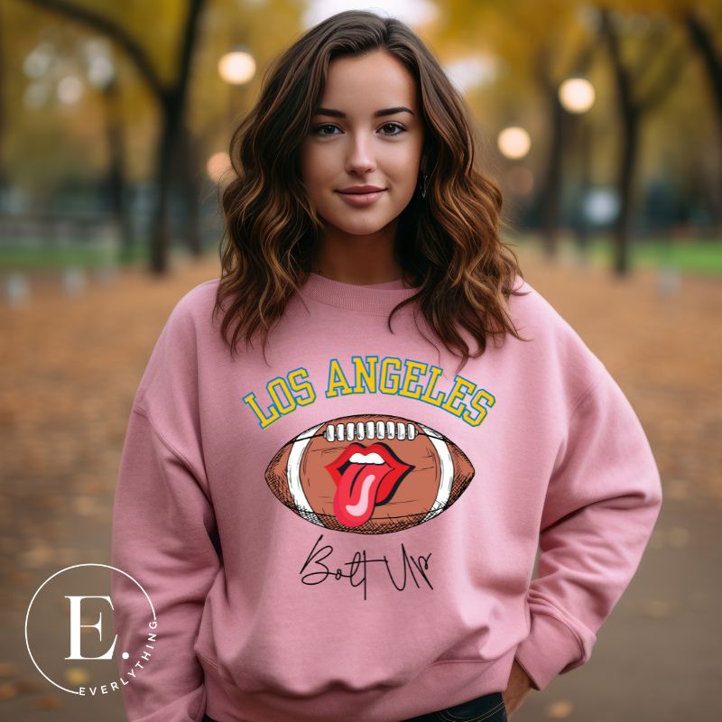 Show off your Los Angeles Chargers pride with our exclusive sweatshirt. It features the team's name and the electrifying slogan "Bolt Up." On a pink sweatshirt. 