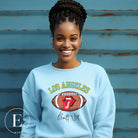 Show off your Los Angeles Chargers pride with our exclusive sweatshirt. It features the team's name and the electrifying slogan "Bolt Up." On a blue sweatshirt. 