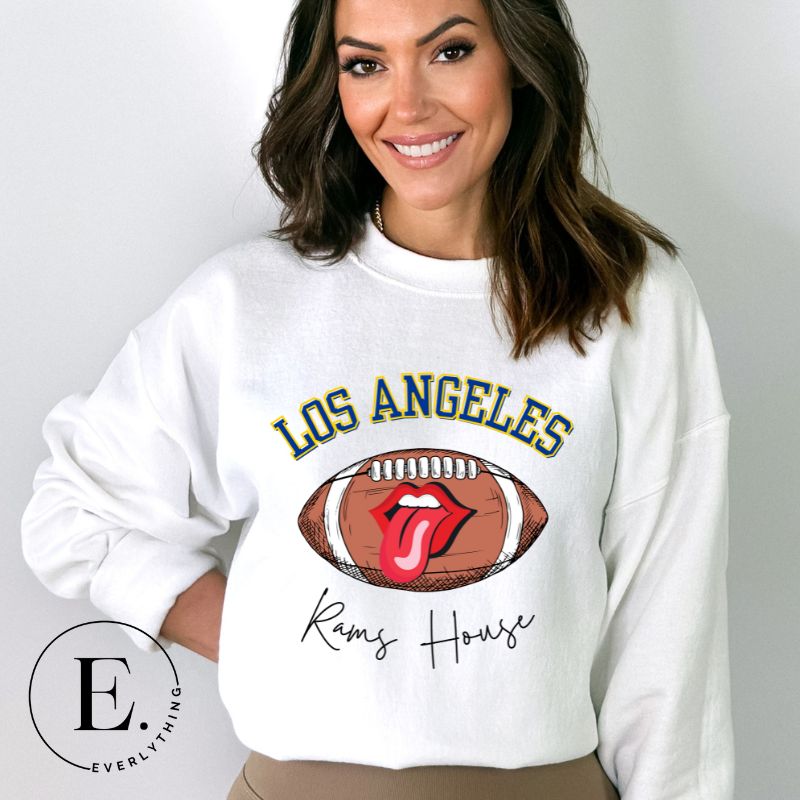 Cheer on the Los Angeles Rams in style with our exclusive sweatshirt featuring the team name and iconic slogan, "Ram House." On a white sweatshirt. 