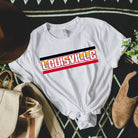 Bella + Canvas 3001 unisex t-shirt featuring the University of Louisville design with red, black, and yellow stripes, and "Louisville" text prominently displayed on a white shirt.