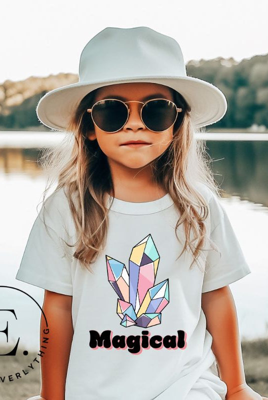 Our kids' shirt is designed to unleash your child's magic. Featuring colorful crystals and the word "Magical", it ignites your child's imagination on a white shirt. 