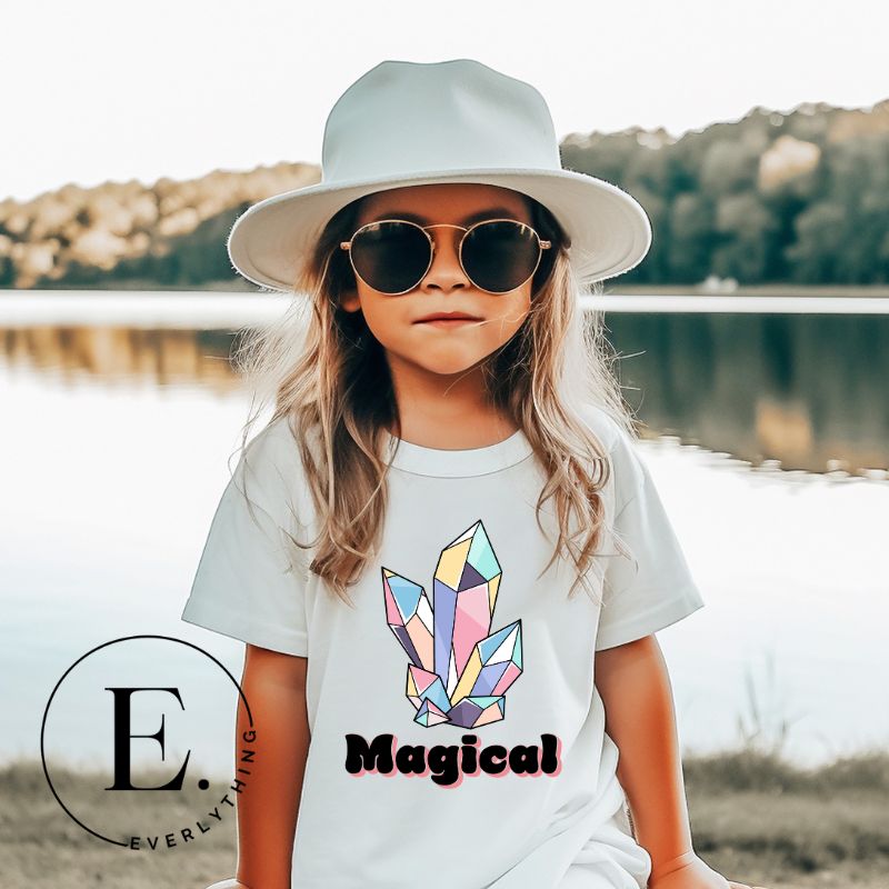 Our kids' shirt is designed to unleash your child's magic. Featuring colorful crystals and the word "Magical", it ignites your child's imagination on a white shirt. 