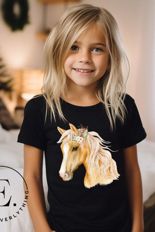 Embrace the equestrian vibe with our kids' shirt which features a majestic horse head adorned with a beautiful floral arrangement on its mane on a white shirt on a black shirt.