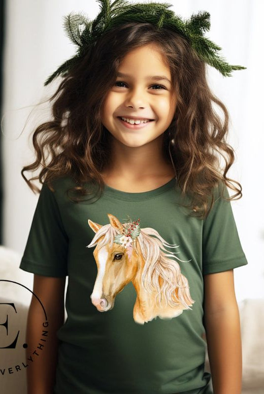 Embrace the equestrian vibe with our kids' shirt which features a majestic horse head adorned with a beautiful floral arrangement on its mane on a white shirt on a green shirt. 