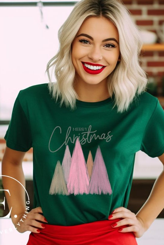 Get into the holiday spirit with our modern minimalist Christmas t-shirt. It features charming pastel Christmas trees with a sleek "Merry Christmas" message above the trees, perfectly blending simplicity and festive cheer on a green shirt. 