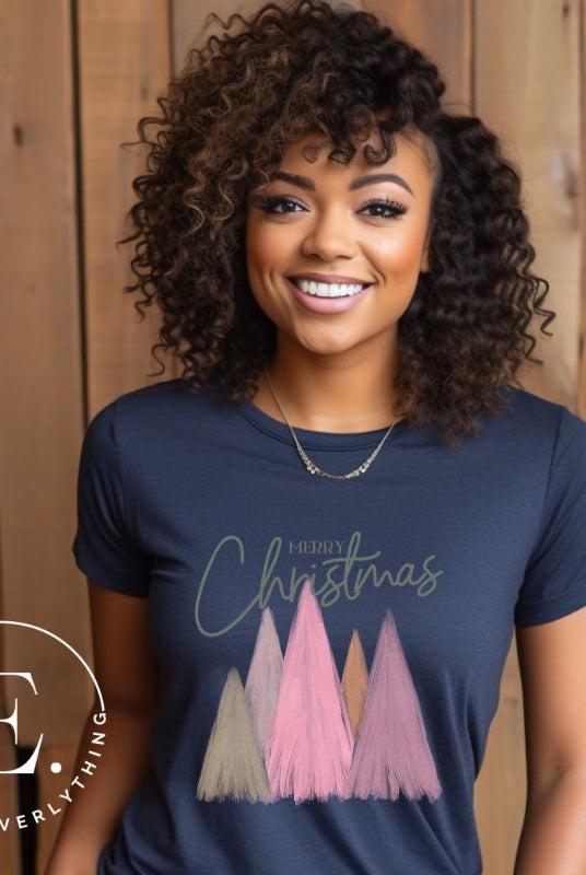 Get into the holiday spirit with our modern minimalist Christmas t-shirt. It features charming pastel Christmas trees with a sleek "Merry Christmas" message above the trees, perfectly blending simplicity and festive cheer on a navy shirt. 