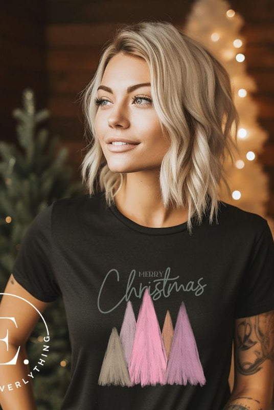 Get into the holiday spirit with our modern minimalist Christmas t-shirt. It features charming pastel Christmas trees with a sleek "Merry Christmas" message above the trees, perfectly blending simplicity and festive cheer on a black shirt.