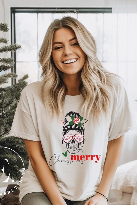 Get into the festive spirit with our Merry Christmas messy bun skull shirt design on a tan colored shirt.