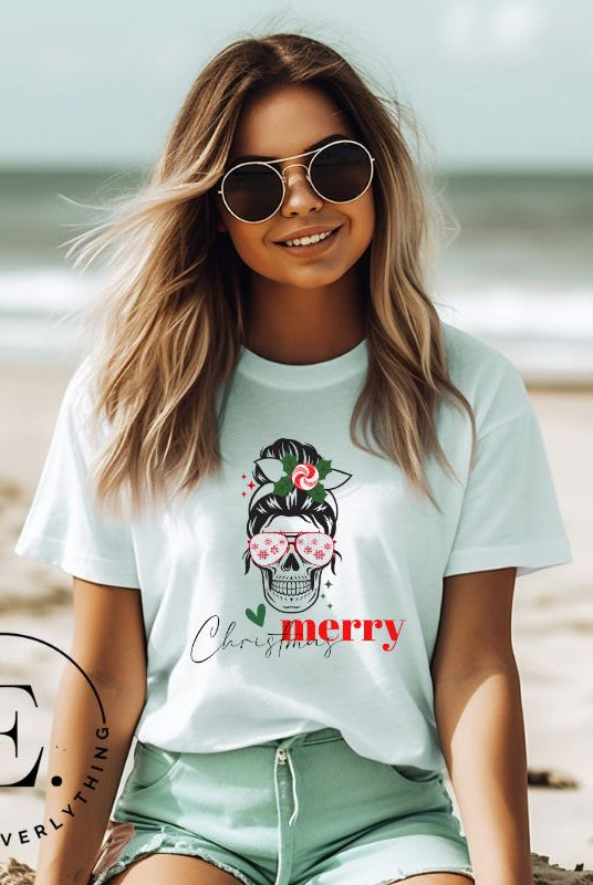 Get into the festive spirit with our Merry Christmas messy bun skull shirt design on a prism blue colored shirt.