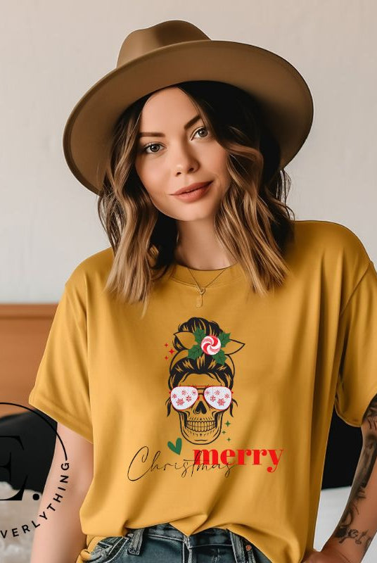 Get into the festive spirit with our Merry Christmas messy bun skull shirt design on a mustard colored shirt.