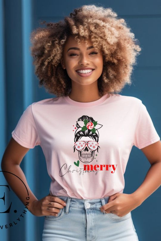 Get into the festive spirit with our Merry Christmas messy bun skull shirt design on a pink colored shirt.