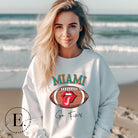 Show off your Miami Dolphins pride with this eye-catching sweatshirt, boasting a football and playful lips and tongue design. Highlighted with the team's motivating slogan "Go Fins" and the iconic Miami wordmark, on a white sweatshirt. 