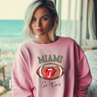 Show off your Miami Dolphins pride with this eye-catching sweatshirt, boasting a football and playful lips and tongue design. Highlighted with the team's motivating slogan "Go Fins" and the iconic Miami wordmark, on a pink sweatshirt. 