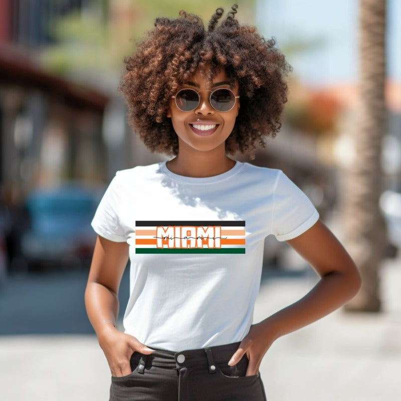 Bella + Canvas 3001 unisex t-shirt featuring the University of Miami design with black, orange, and green stripes and "Miami" text in the center on a white shirt.