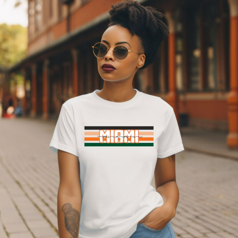 Bella + Canvas 3001 unisex t-shirt featuring the University of Miami design with black, orange, and green stripes and "Miami" text in the center on a white shirt.