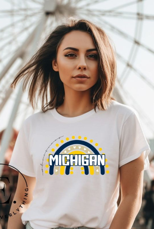Unleash your vibrant spirit with our Michigan graphic tee. Adorned with a rainbow in school colors and "Michigan" in playful block bubble lettering, this shirt exudes energy and Wolverine pride on a white shirt. 