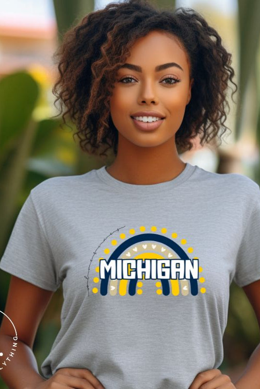 Unleash your vibrant spirit with our Michigan graphic tee. Adorned with a rainbow in school colors and "Michigan" in playful block bubble lettering, this shirt exudes energy and Wolverine pride on a grey shirt. 