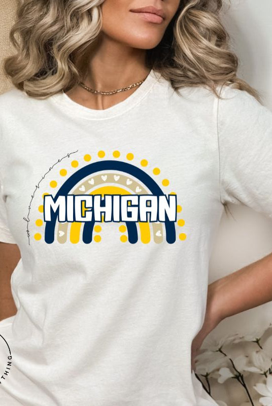 Unleash your vibrant spirit with our Michigan graphic tee. Adorned with a rainbow in school colors and "Michigan" in playful block bubble lettering, this shirt exudes energy and Wolverine pride on a white shirt. 