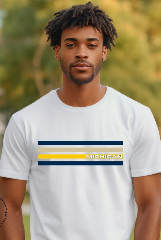 Revive retro collegiate fashion with our Michigan graphic tee. Bosting classic school colors and minimalist design, this men's shirt features distinctive chest stripes with "Michigan" in bold block lettering on a white shirt. 