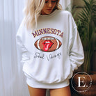 Elevate your game-day look with this Minnesota Viking sweatshirt, featuring a football and unique lips and tongue design. Complete with the team's rallying cry " Skol Vikings" and the iconic Minnesota wordmark, on this white sweatshirt. 