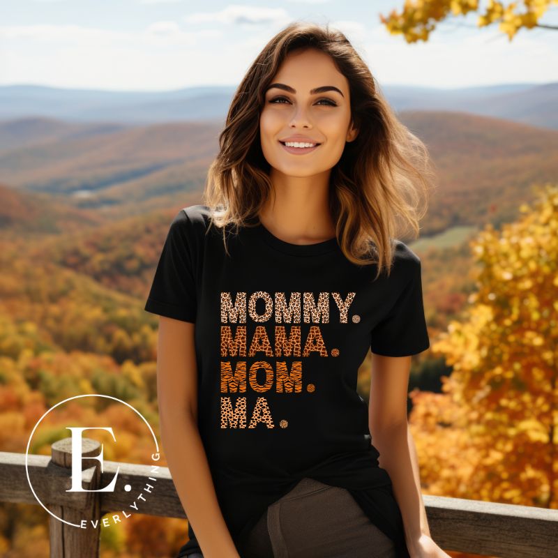 Express motherhood's beautiful chaos with our 'Mommy Mama Mom Ma' tee! Celebrate the different ways your little ones call you with this fun and stylish shirt on a black shirt. 