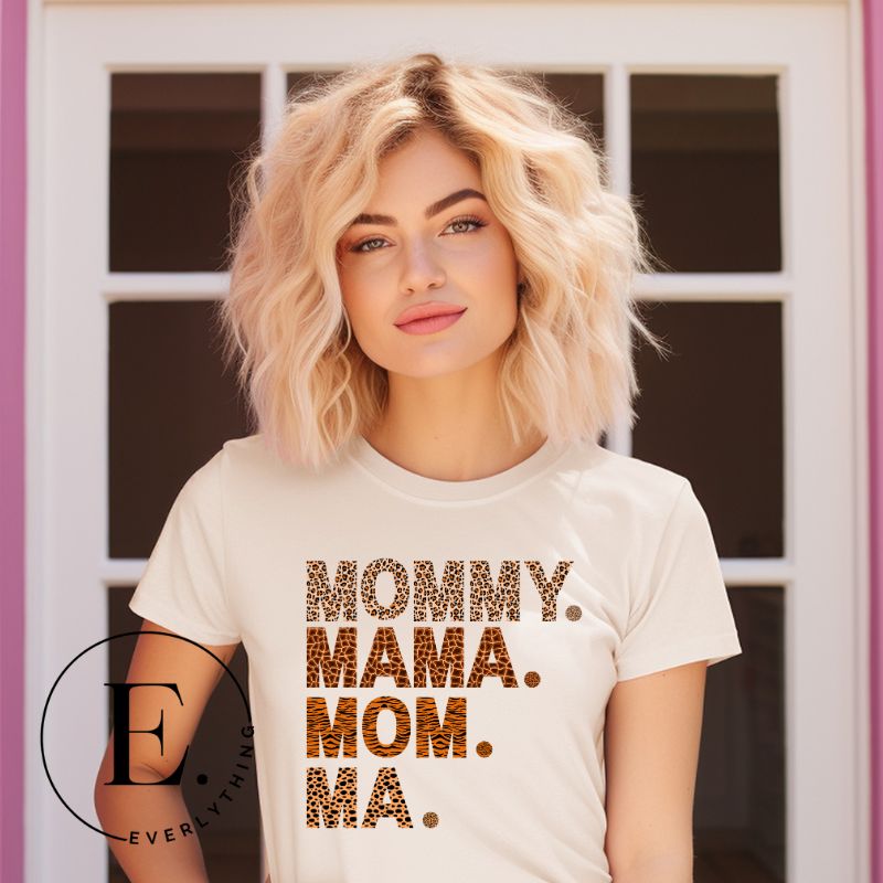 Express motherhood's beautiful chaos with our 'Mommy Mama Mom Ma' tee! Celebrate the different ways your little ones call you with this fun and stylish shirt on a soft cream shirt. 
