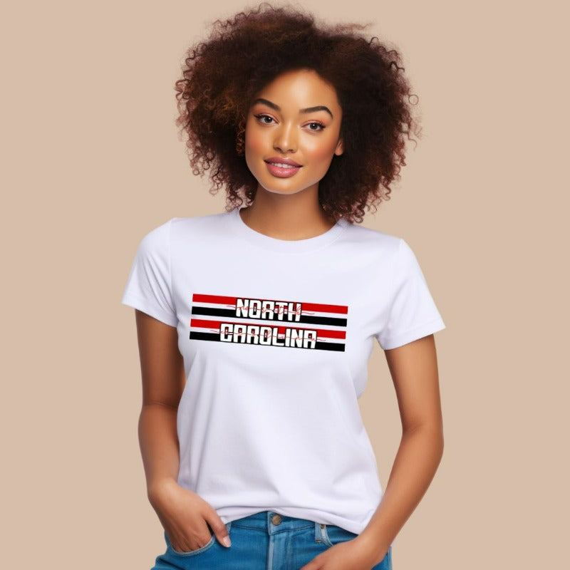 "North Carolina" in bold red and white text on a black and red striped background across the chest on a white shirt.