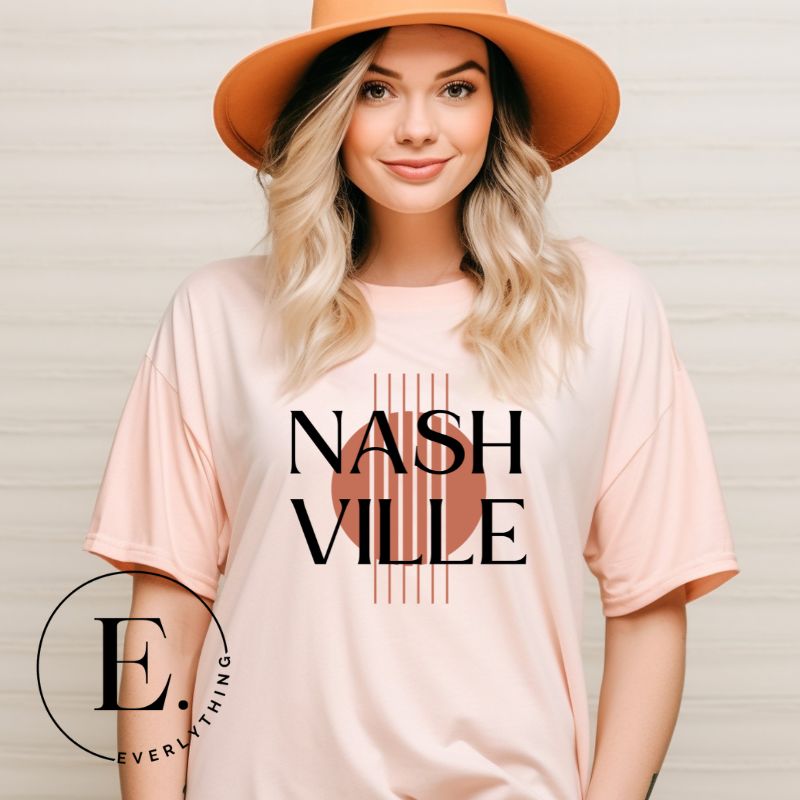 Capture the essence of Nashville with our minimalistic country western T-shirt. Featuring the iconic word "Nashville" with guitar strings silhouette, on a peach shirt. 