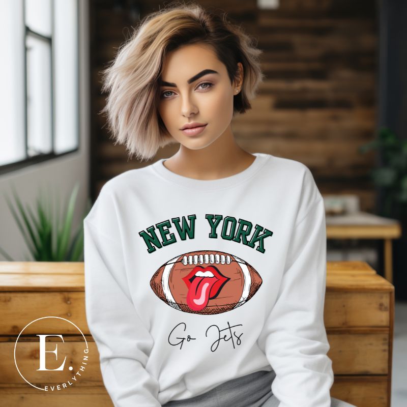 Gear up for game day with this New York Jets sweatshirt, featuring a football and playful lips and tongue design. Emblazoned with the team's rallying cry "Go Jets" and the iconic wordmark New York, on a white sweatshirt. 