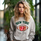 Gear up for game day with this New York Jets sweatshirt, featuring a football and playful lips and tongue design. Emblazoned with the team's rallying cry "Go Jets" and the iconic wordmark New York, on a grey sweatshirt. 