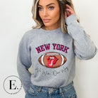 Elevate your game-day attire with this New York Giants sweatshirt, featuring a football and unique lips and tongue design. Highlighted with the team's empowering slogan "We Win Our Way" and the iconic New Yor wordmark, on a grey sweatshirt. 