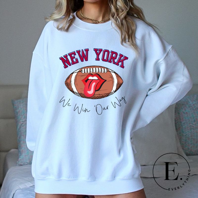 Elevate your game-day attire with this New York Giants sweatshirt, featuring a football and unique lips and tongue design. Highlighted with the team's empowering slogan "We Win Our Way" and the iconic New Yor wordmark, on a white sweatshirt. 