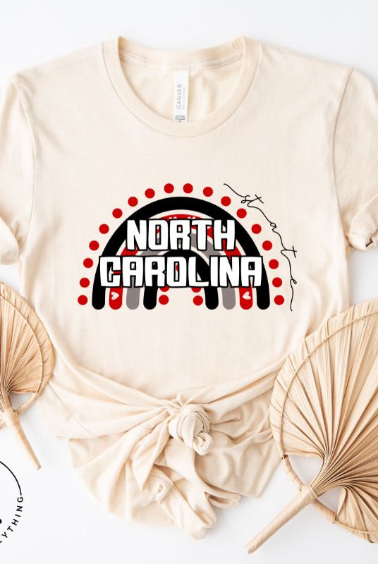 Looking for a way to show off your vibrant spirit? Look no further than this NC State University t-shirt. The NC State colors shine on a boho rainbow backdrop, representing the iconic North Carolina wordmark in a unique and trendy way on a soft cream shirt.
