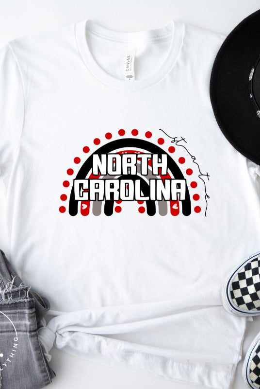 Looking for a way to show off your vibrant spirit? Look no further than this NC State University t-shirt. The NC State colors shine on a boho rainbow backdrop, representing the iconic North Carolina wordmark in a unique and trendy way on a white shirt. 