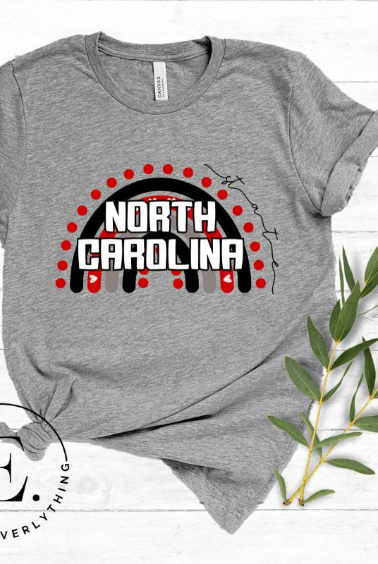 Looking for a way to show off your vibrant spirit? Look no further than this NC State University t-shirt. The NC State colors shine on a boho rainbow backdrop, representing the iconic North Carolina wordmark in a unique and trendy way on a grey shirt. 
