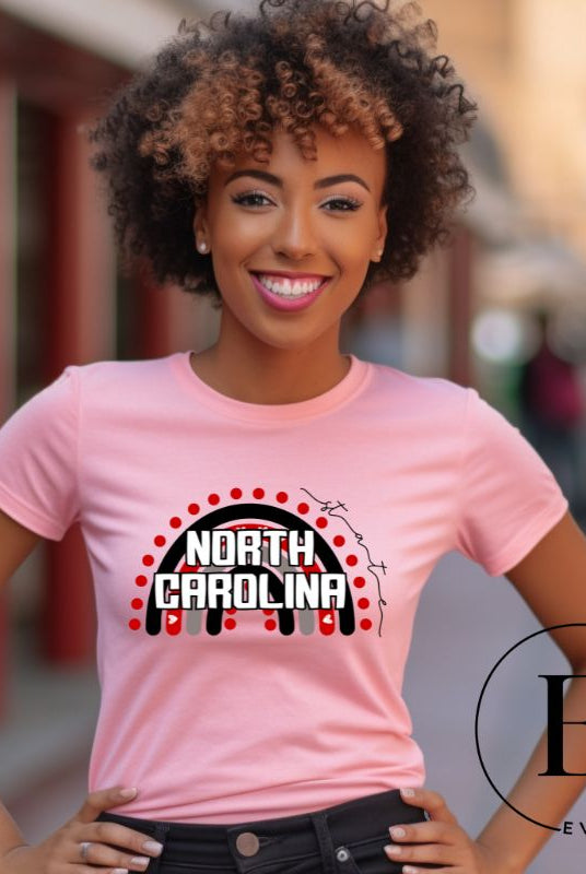 Looking for a way to show off your vibrant spirit? Look no further than this NC State University t-shirt. The NC State colors shine on a boho rainbow backdrop, representing the iconic North Carolina wordmark in a unique and trendy way on a pink shirt. 